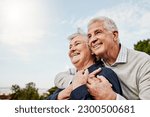 Sky, elderly couple and hug outdoors or happy in retirement or husband and wife in nature. Mature, man and woman smile in vacation or senior citizens care and embrace or date at the park for romance