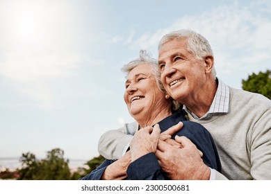 Sky, elderly couple and hug outdoors or happy in retirement or husband and wife in nature. Mature, man and woman smile in vacation or senior citizens care and embrace or date at the park for romance