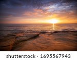 The sky erupts in vibrant colors, as the sun sets over the Pacific Ocean, at Sunset Cliffs in San Diego, California.