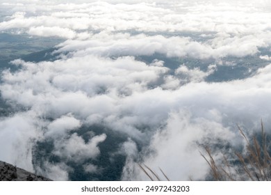 The sky is filled with clouds, creating a moody and somewhat ominous atmosphere. The clouds are low and heavy, covering the entire sky and casting a shadow over the land below