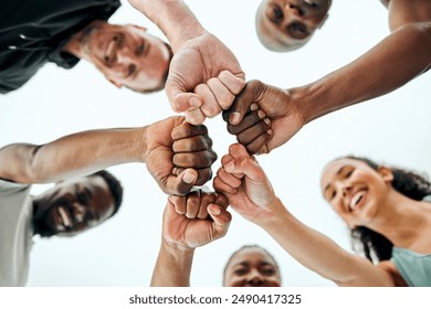 Sky, fist bump and fitness people in outdoor for teamwork, support or running motivation. Low angle, diversity and group of friends with smile for synergy, community or race in morning in Spain - Powered by Shutterstock