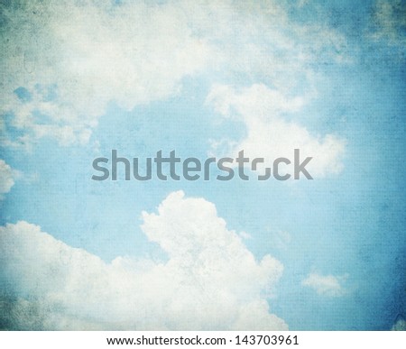 Sky, fog, and clouds on a textured, vintage paper background with grunge stains.