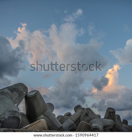 The sky full of firey clouds during sunset over a Cretan port