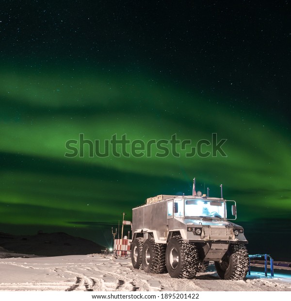 In\
the sky a green polar lights. Landscape of\
Antarctica.
