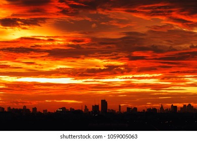 Sky image with  a dramatic red clouds after sunset and silhouettes of buildings