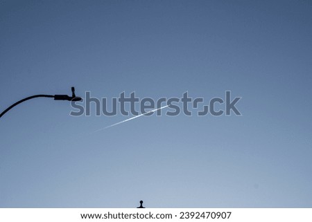 sky with lamp post and cloud made from an airplane