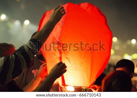  sky lantern being held by tourists closeup  in Saint John bonfires in Coruna  Galicia, feast of  international Tourist Interest