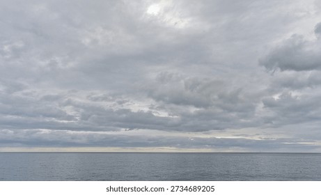 sky with layers of grey clouds over calm the Atlantic Ocean