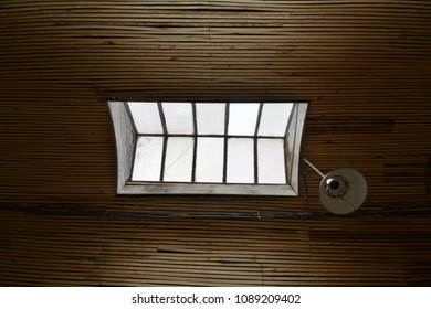 Sky Light, Wood Ceiling And Broken Light Fixture In An Abandoned Building