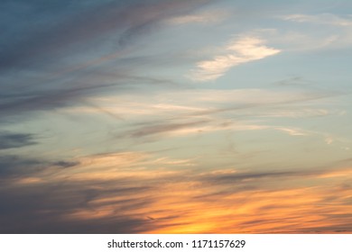 the sky lights up with a blue, green, and orange sunset - Shutterstock ID 1171157629
