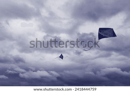 Sky and objects, two flying paper dragons, in the background of heaven with clouds, flying beautiful kites, autumn view, dark blue color