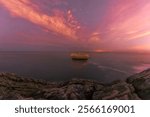 sky with pink tones due to the solar storm in January 2025 from the cliffs of Islares, Cantabria