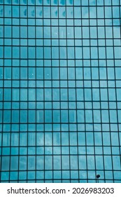 The sky is reflected in the window of a skyscraper in Tokyo, Japan.