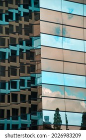 The sky is reflected in the window of a skyscraper in Tokyo, Japan.