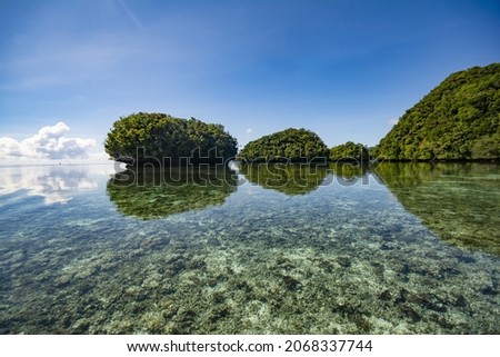 Sky, reflection, small islands and Ocean, Rock Islands Southern Lagoon, World heritage site in Koror state, Palau