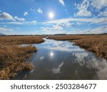 Sky reflection in the water of the wetlands in Secaucus, New Jersey 