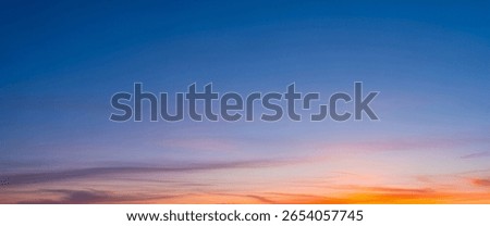 Sky showing smooth gradient colors shifting from soft blue to warm orange near the horizon, creating a balanced natural tone ideal for background use or landscape scenes.