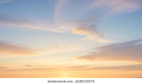 Sky with soft clouds and a gradient of orange blue and pink colors.