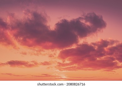 Сloudy sky at sunset.  Sky texture, abstract nature background in trendy Calming Coral color