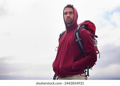 Sky, thinking and man with backpack, camping or hiking in nature for adventure and peace. Contemplation, vacation and male person in trip, thoughtful and journey for holiday and outdoor for relax - Powered by Shutterstock