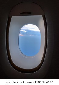 The sky through a window of a plane