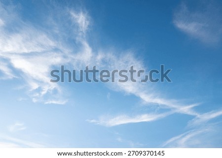 The sky is a vibrant, cloudless blue, while the sun shines brightly, making it appear even more radiant.