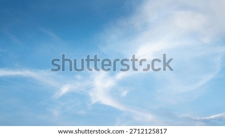The sky is a vibrant, cloudless blue, while the sun shines brightly, making it appear even more radiant.