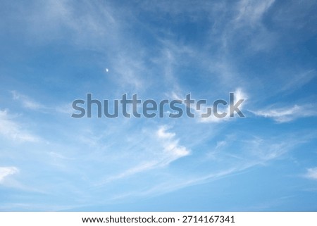 The sky is a vibrant, cloudless blue, while the sun shines brightly, making it appear even more radiant.