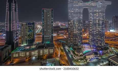 Sky view to skyscrapers and hotels in Dubai downtown aerial timelapse. Modern architecture illuminated at night. City walk district on a background