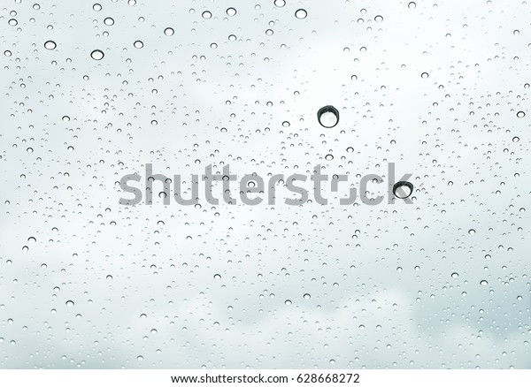 sky view through\
car window with rain drops
