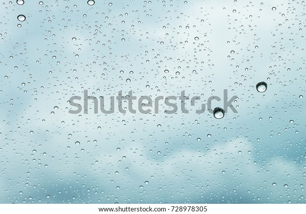 sky view through\
car window with rain drops