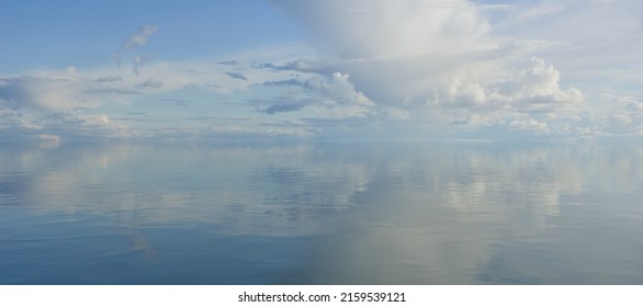sky and water. a calm landscape of clouds reflecting in the water - Shutterstock ID 2159539121