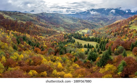 Sky with white and fluffy layer of clouds over green autumn hills, Aerial panoramic drone shot