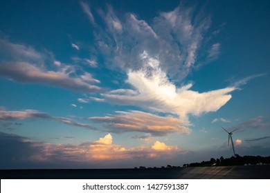 Sky With Wind Turbine For Electricity Generating In The Bright Evening, Abstract Cloud Over Blue Blackgrond, Taken By Wide Angle Lens