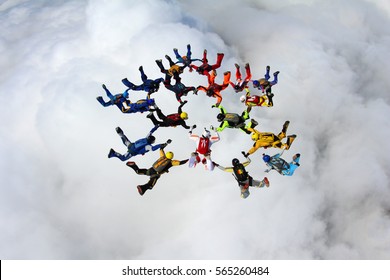 Skydive Formation Is Flying Above The White Clouds.