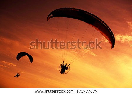 Skydiver against sunset