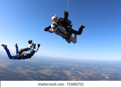 Skydiver cameraman is filming a tandem jump.