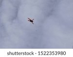 A skydiver is falling into white clouds.