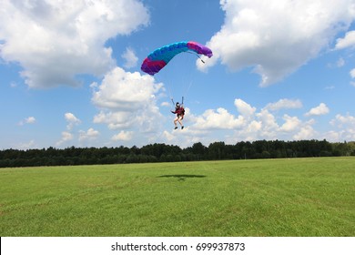 Skydiver girl is landing.