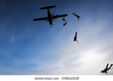 Skydiver Jumping From The Plane At The Sunset.