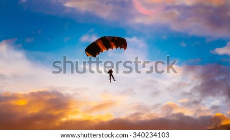 Skydiver On Colorful Parachute In Sunny Sunset Sunrise Sky. Active Lifestyle