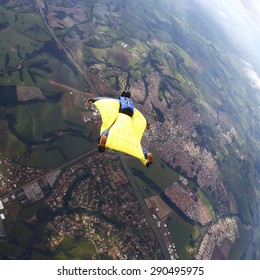 Skydiver Wing Suit Flying, Yellow Suit. Adventure Freedom Concept.