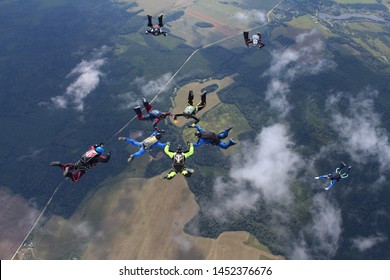 Skydivers are doing a formation in the sky.