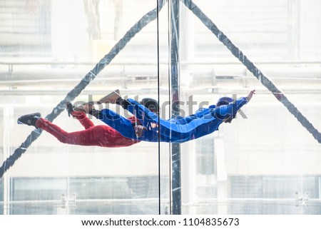 Skydivers in indoor wind tunnel, free fall simulator