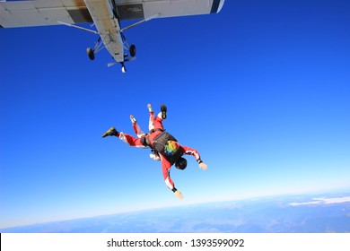 Skydivers Are Jumping Out Of Plane Flying In The Sky In Nelson, New Zealand.