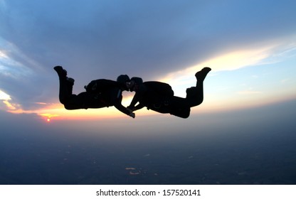 Skydiving Couple Kissing In Free Fall. Togetherness Concept.