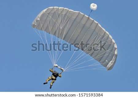 Skydiving -extreme sports- parachutist with a parachute unfolded.