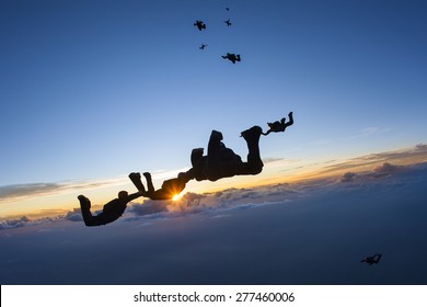 Skydiving formation at sunset