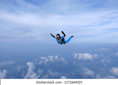 Skydiving. Girl In Blue Suit Is In The Sky.