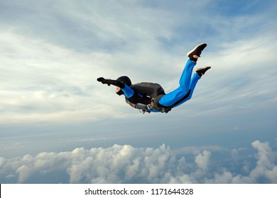 Skydiving. Girl In Blue Suit Is In The Sky.